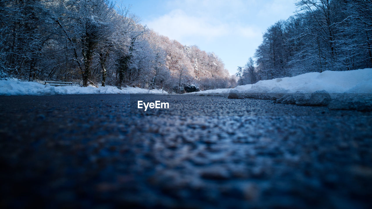 winter, tree, snow, cold temperature, plant, nature, freezing, sky, frost, morning, no people, sunlight, blue, frozen, road, beauty in nature, environment, scenics - nature, tranquility, landscape, tranquil scene, cloud, surface level, land, day, transportation, outdoors, ice, non-urban scene, reflection