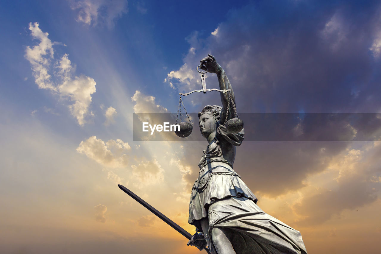 Lady justice with dramatic sky
