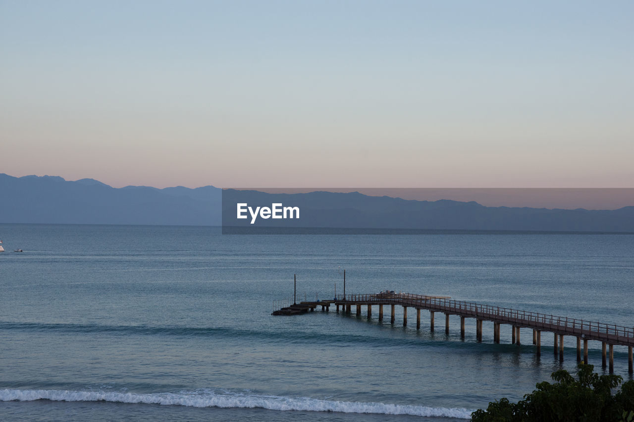 Scenic view of sea against clear sky during sunset