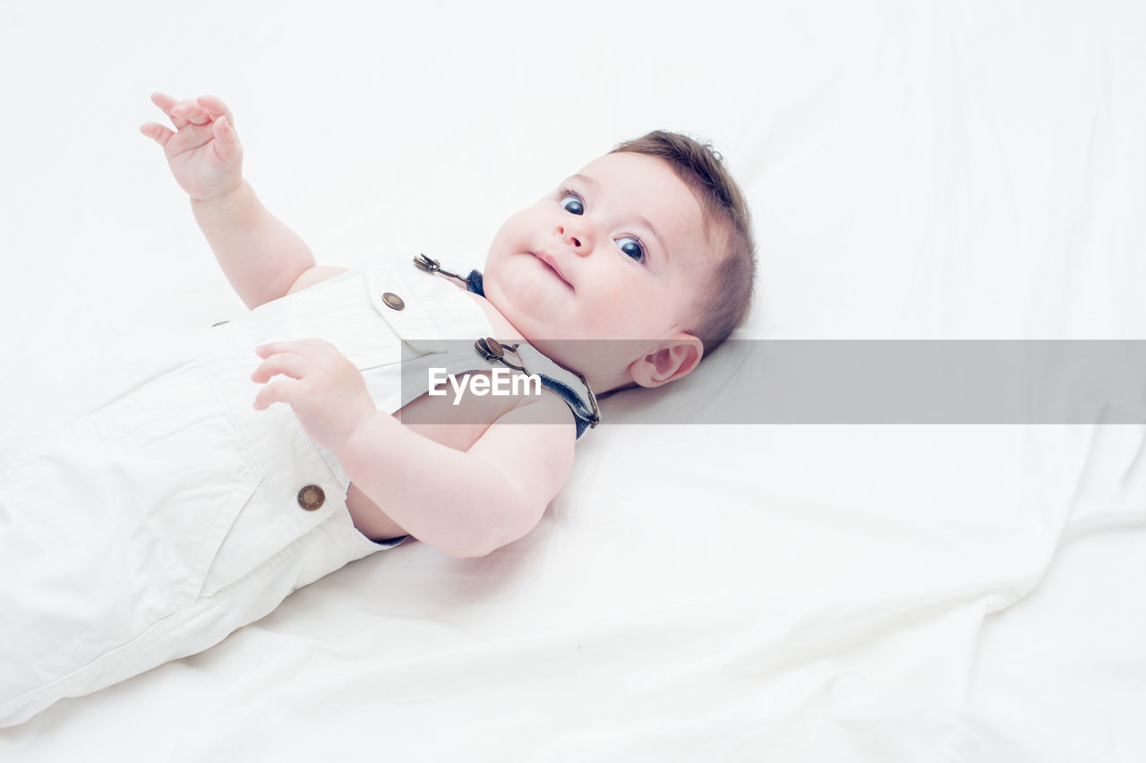 CUTE BOY LYING ON BED