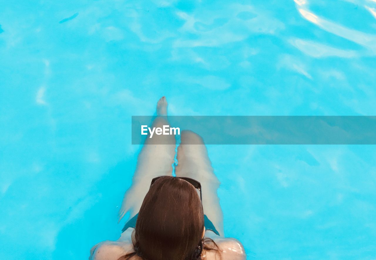 High angle view of woman swimming in pool