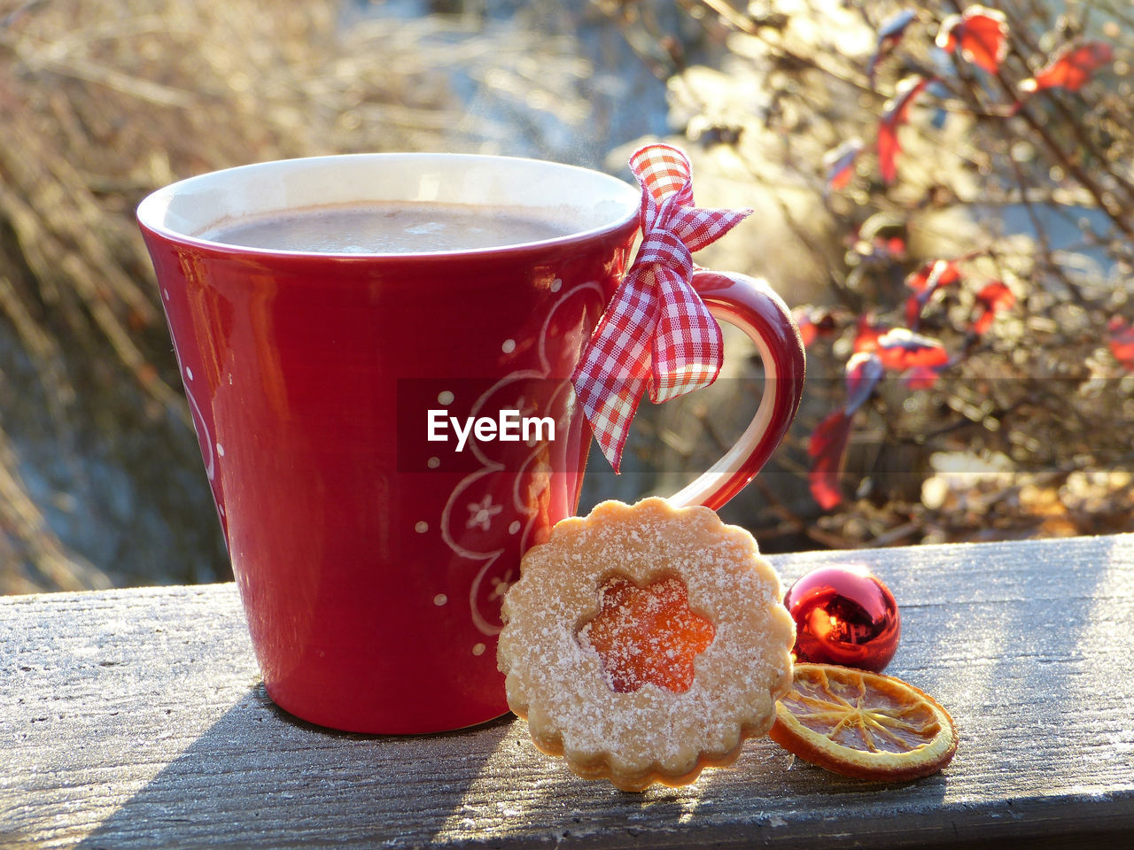 Close-up of coffee cup with cookie on table