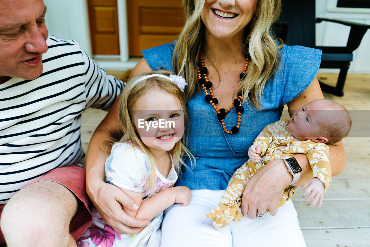 Cropped portrait of a family embraced and laughing together