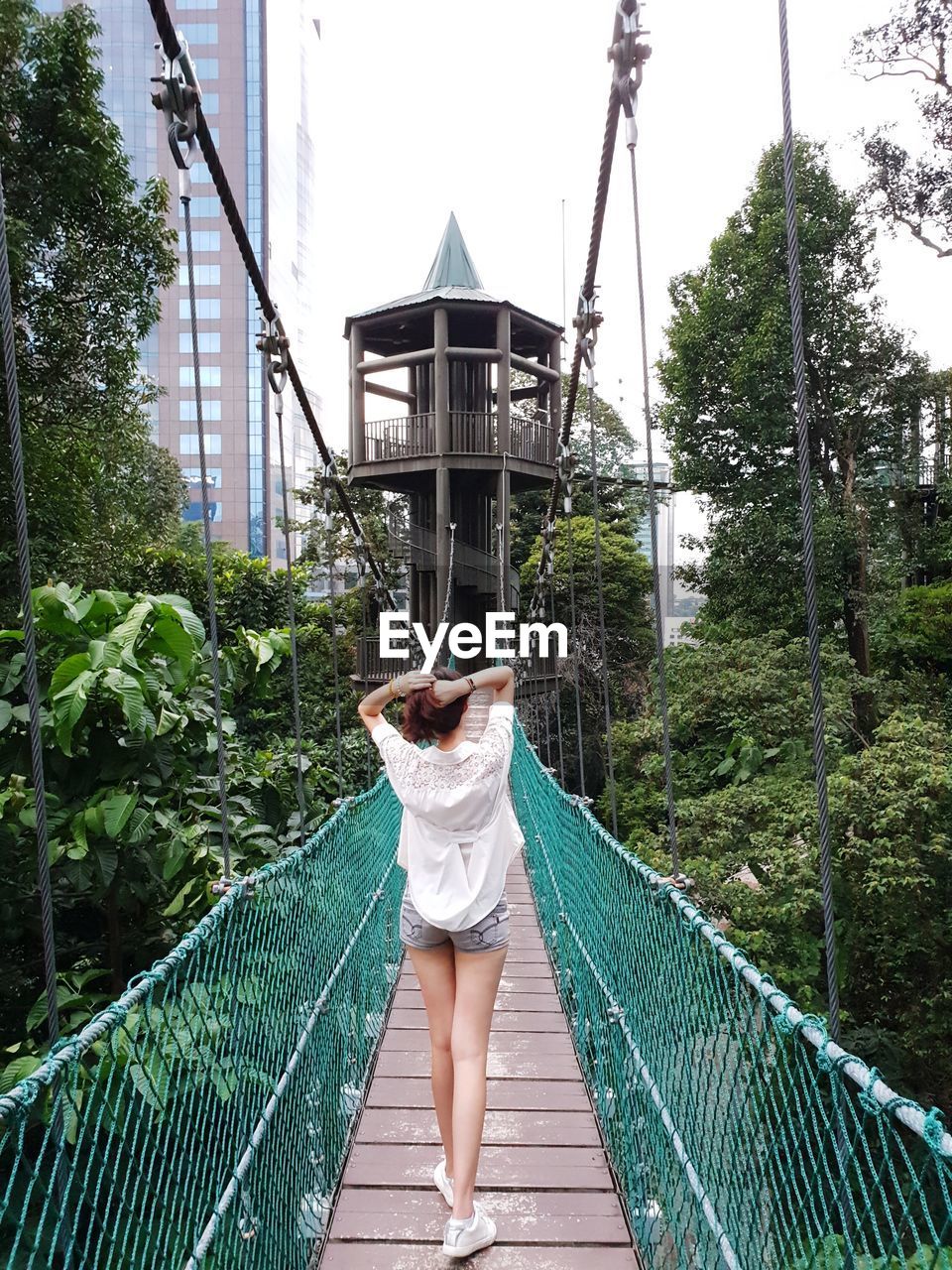 Woman standing on bridge