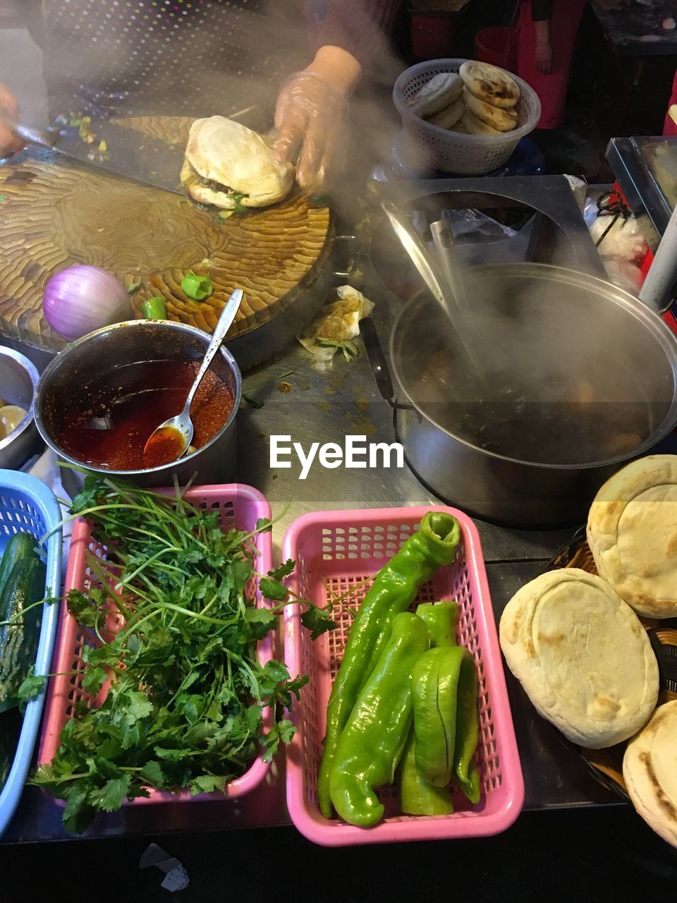High angle view of chef preparing rou jia mo on street food stall