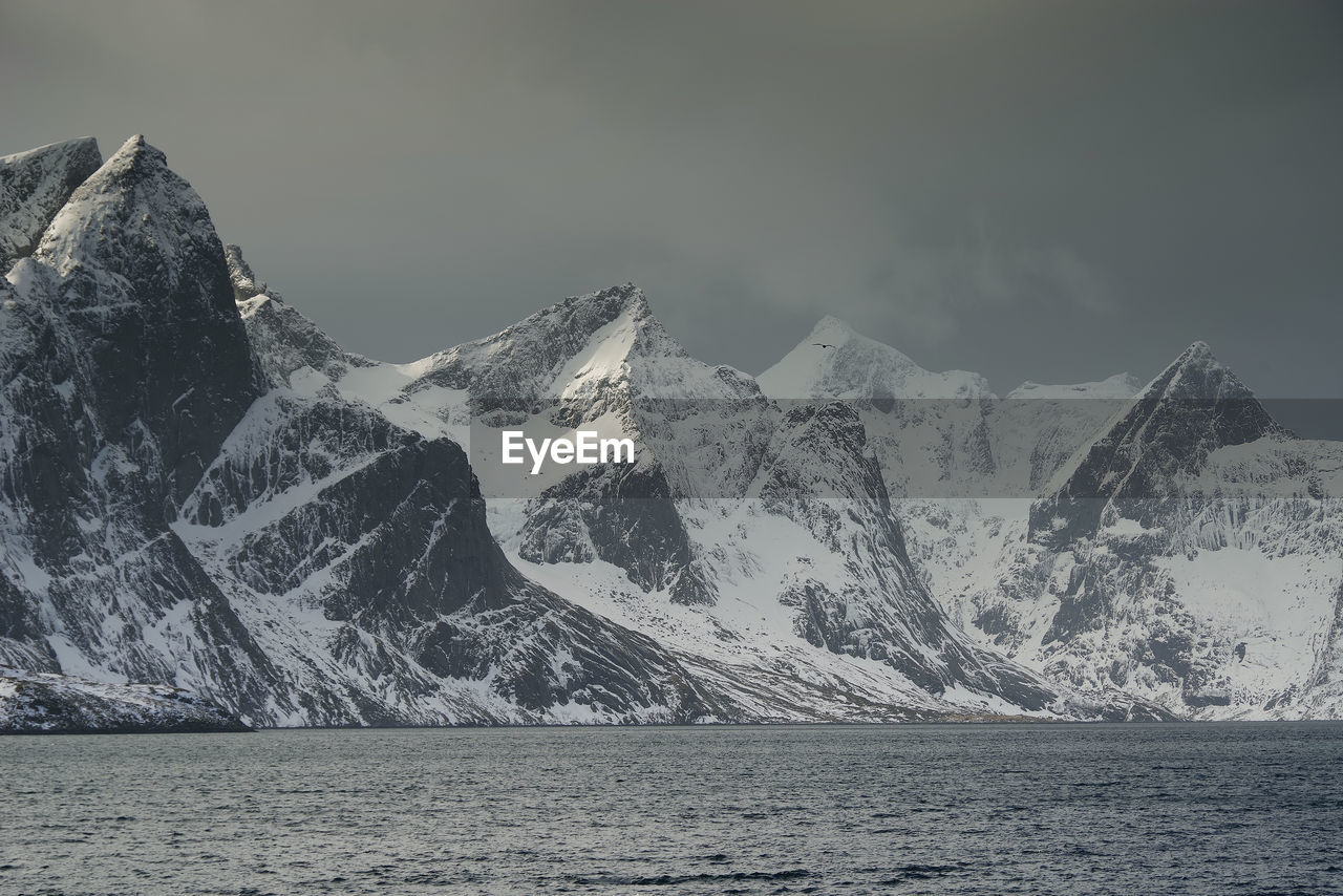 Scenic view of snowcapped mountains against sky during winter