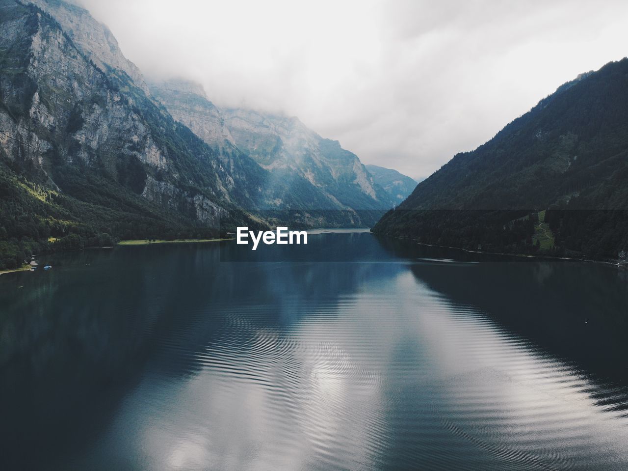 Scenic view of lake and mountains against sky