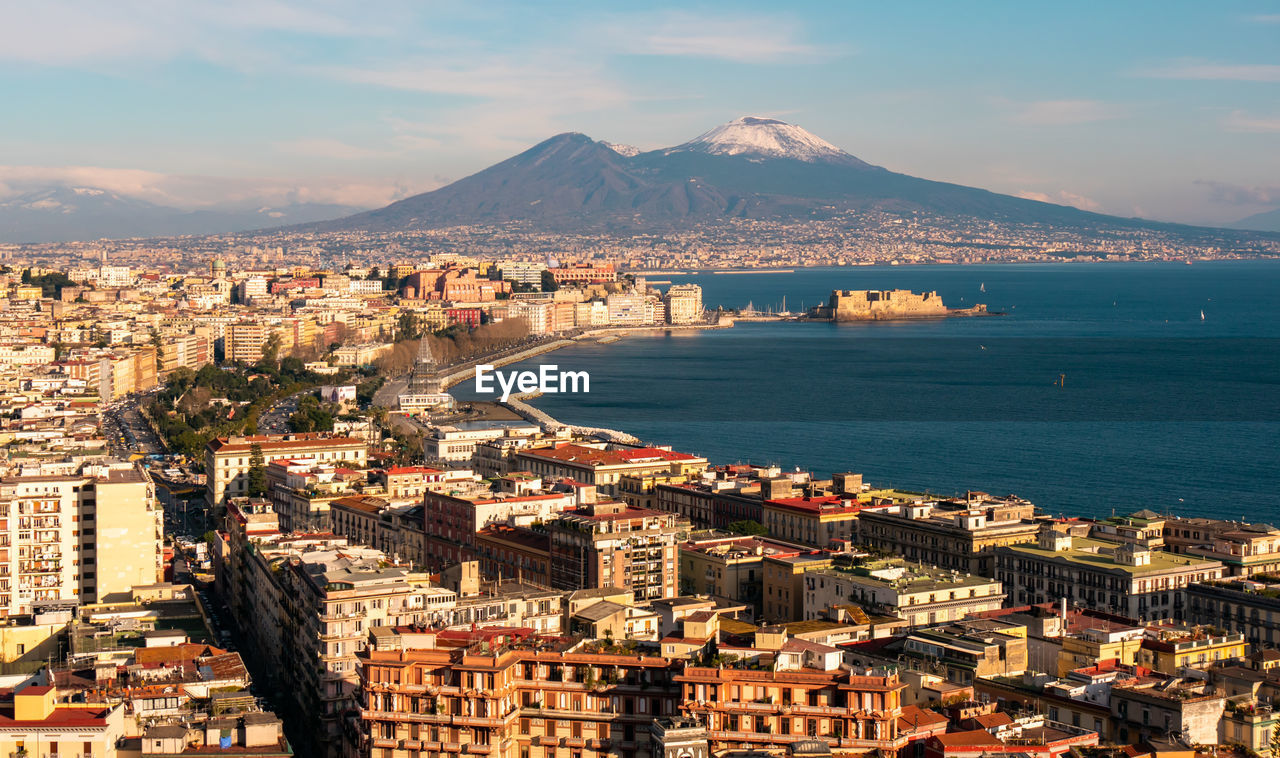 Panoramic aerial view of naples with the unusually snowy vesuvius volcano. campania, southern italy