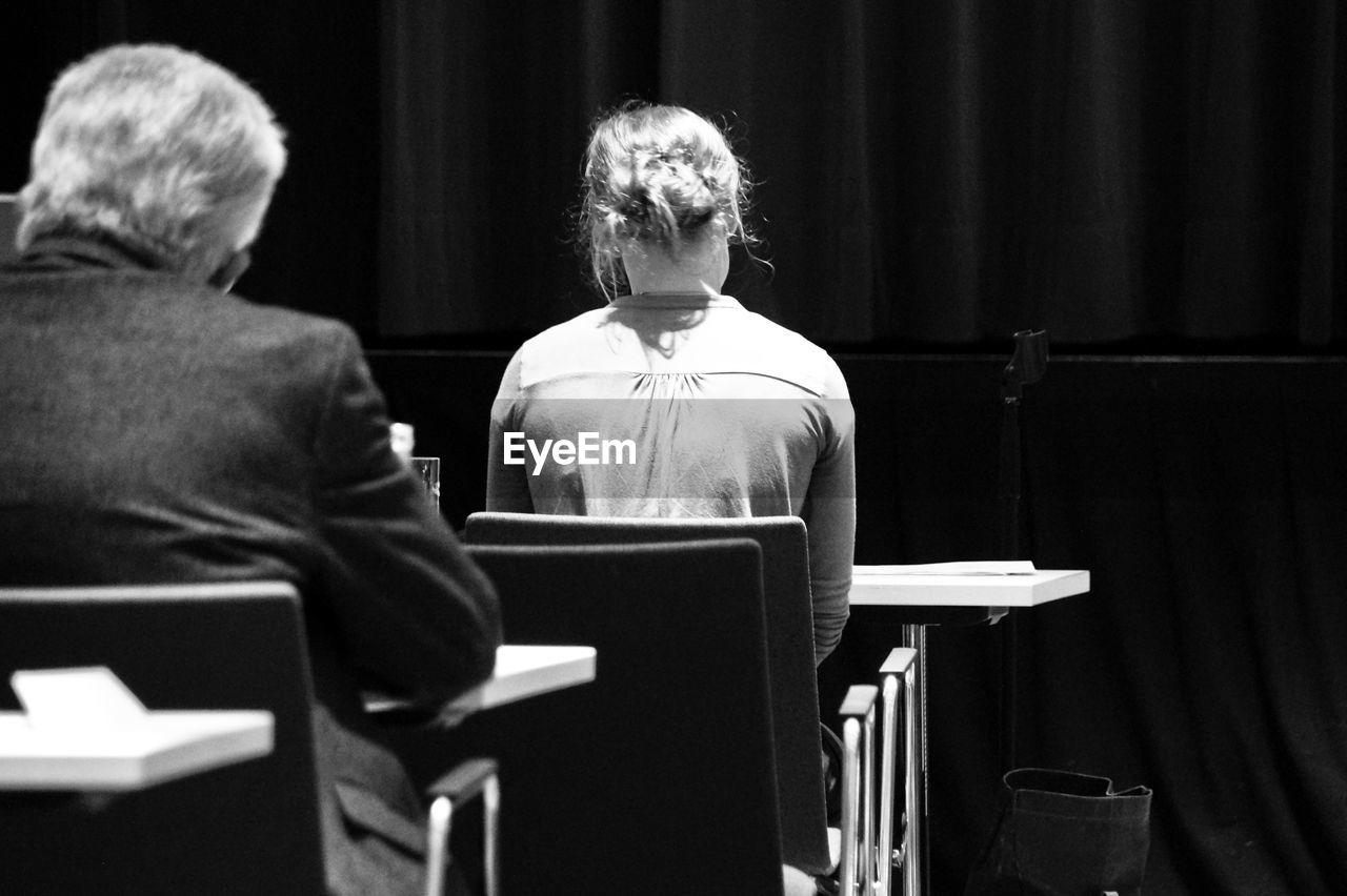 Rear view of people sitting in auditorium