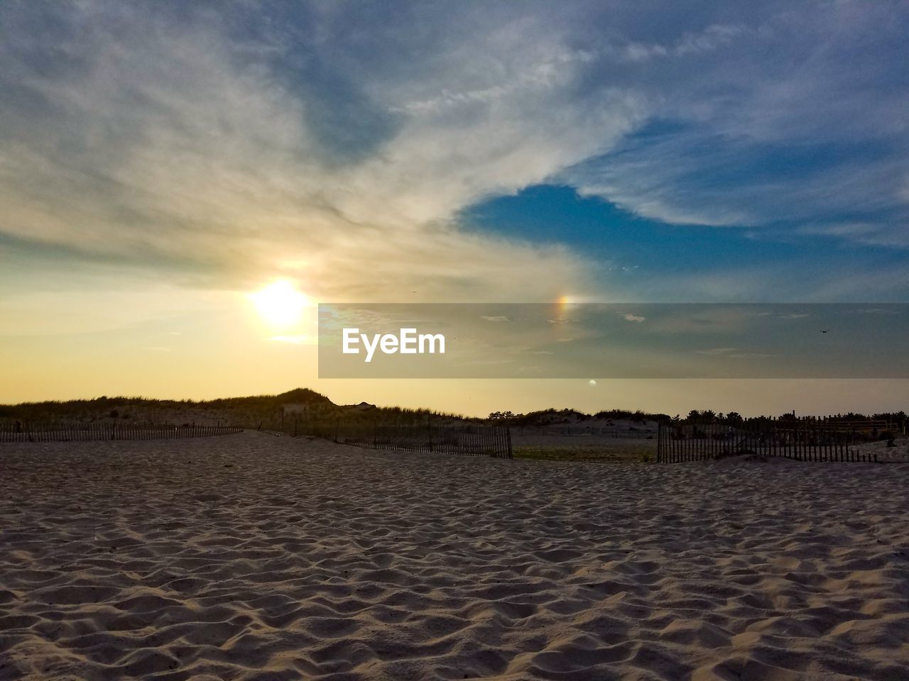 SCENIC VIEW OF SUNSET OVER BEACH