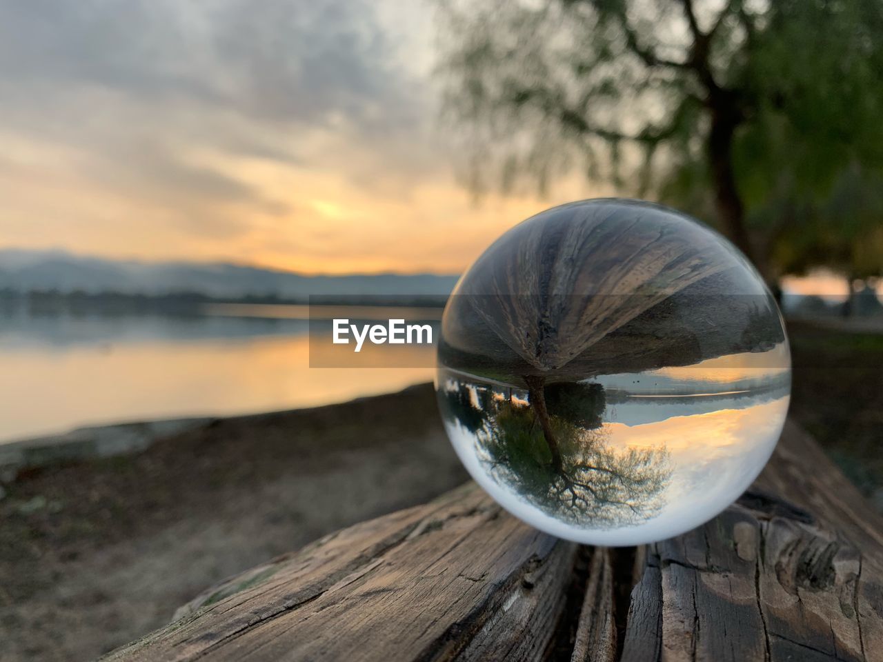 CLOSE-UP OF CRYSTAL BALL ON WATER AT SUNSET