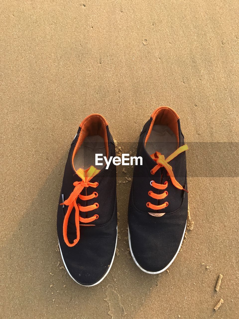 High angle view of shoes on sand at beach