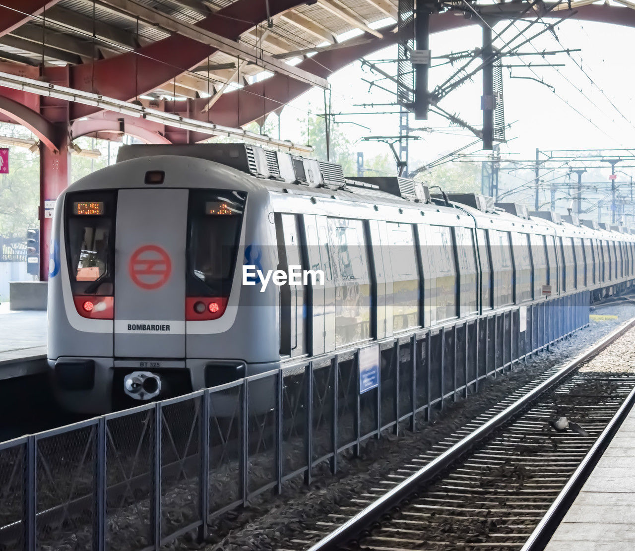 Delhi metro train arriving at jhandewalan metro station in new delhi, india, public metro departing