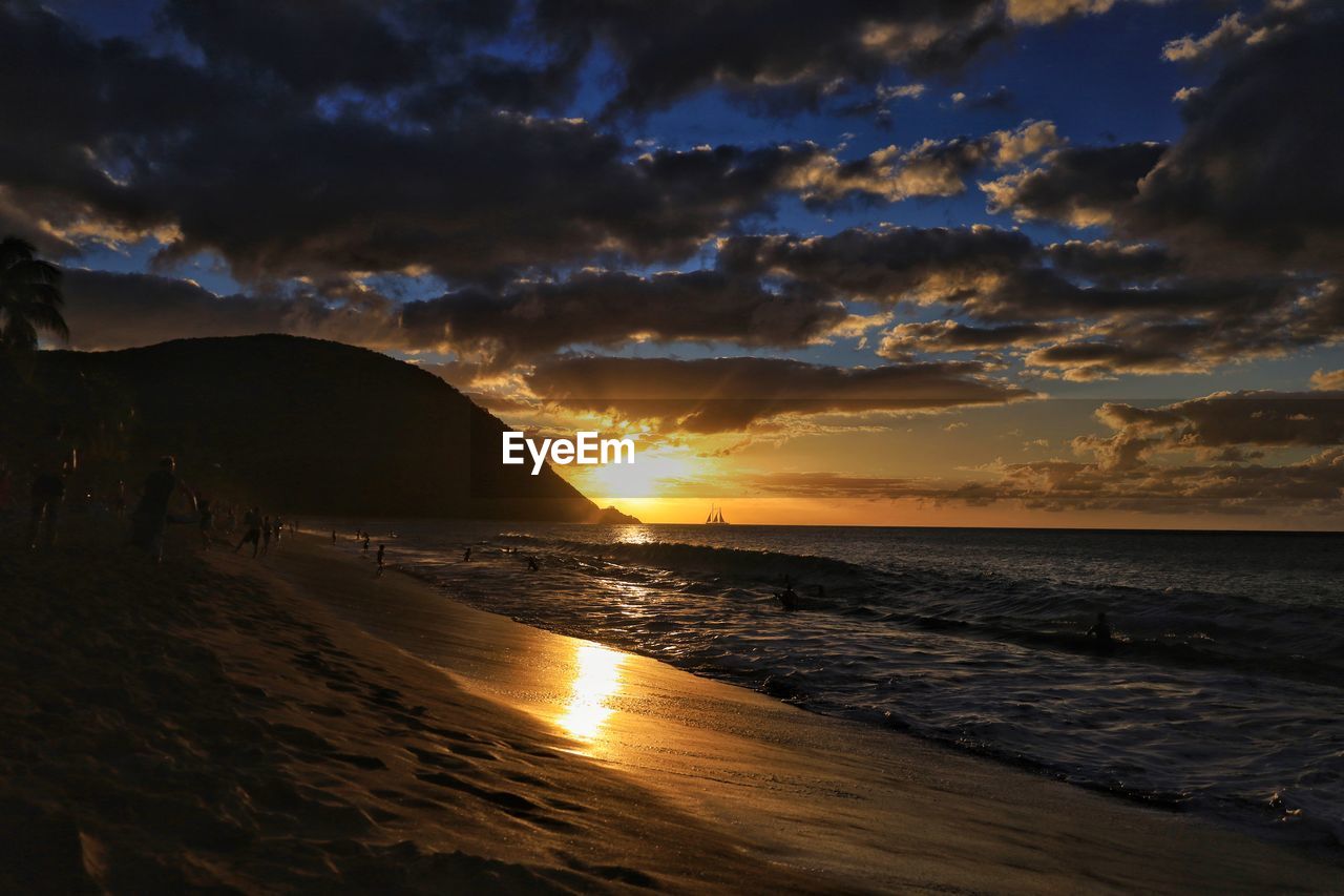 sky, sea, water, land, beach, sunset, cloud, beauty in nature, scenics - nature, nature, coast, wave, horizon, ocean, environment, sunlight, tranquility, dramatic sky, sand, sun, dawn, seascape, evening, travel destinations, landscape, tranquil scene, reflection, travel, horizon over water, outdoors, shore, motion, wind wave, no people, coastline, holiday, vacation, afterglow, trip, idyllic, orange color, tourism, mountain