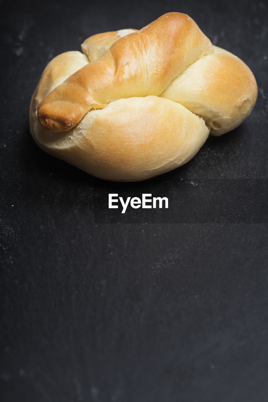 High angle view of pretzel against black background