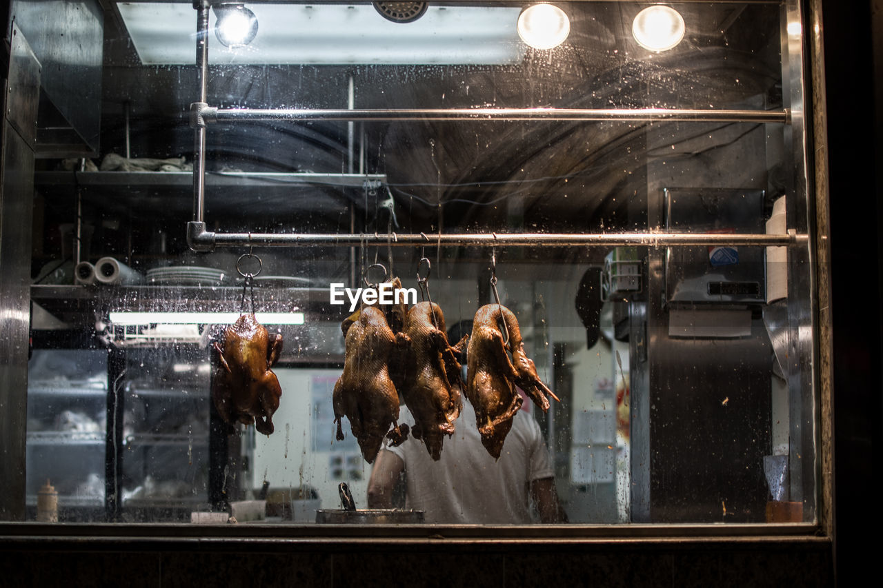 Meat hanging in glass window