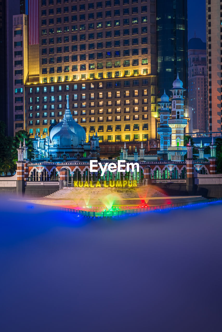 VIEW OF ILLUMINATED BUILDING AT NIGHT