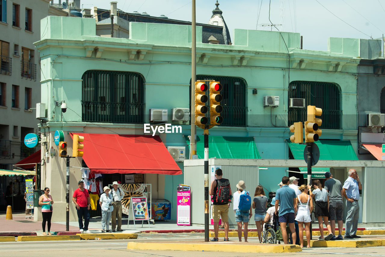 PEOPLE ON STREET AGAINST BUILDINGS