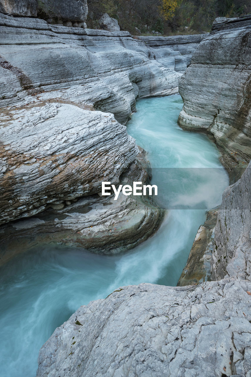 Scenic view of waterfall against sky