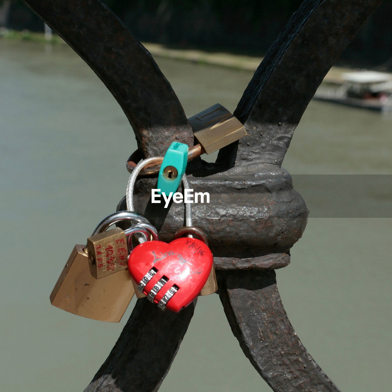 CLOSE-UP OF LOVE PADLOCKS HANGING ON METAL