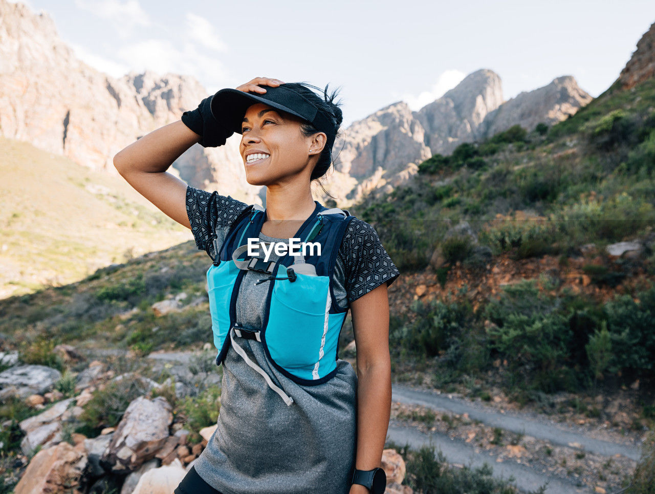 side view of woman standing on mountain