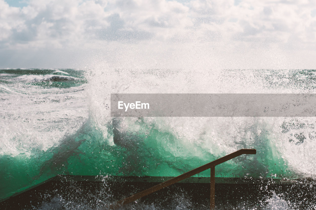 Close-up of waves in sea against sky