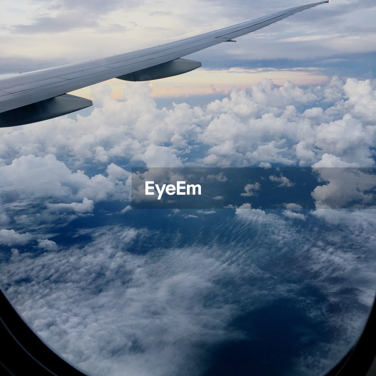 AERIAL VIEW OF CLOUDS OVER AIRPLANE WING