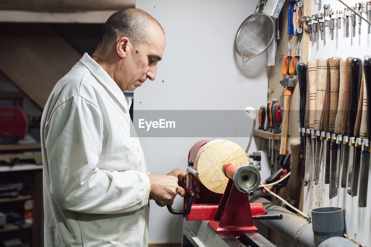 Side view of a man working in workshop