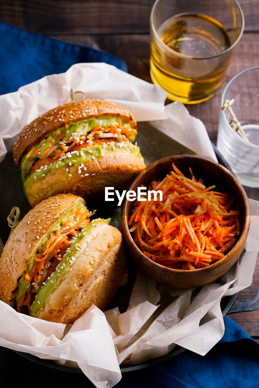 Plant based vegan sweet potato or pumpkin burgers with avocado guacamole sauce and carrot slaw