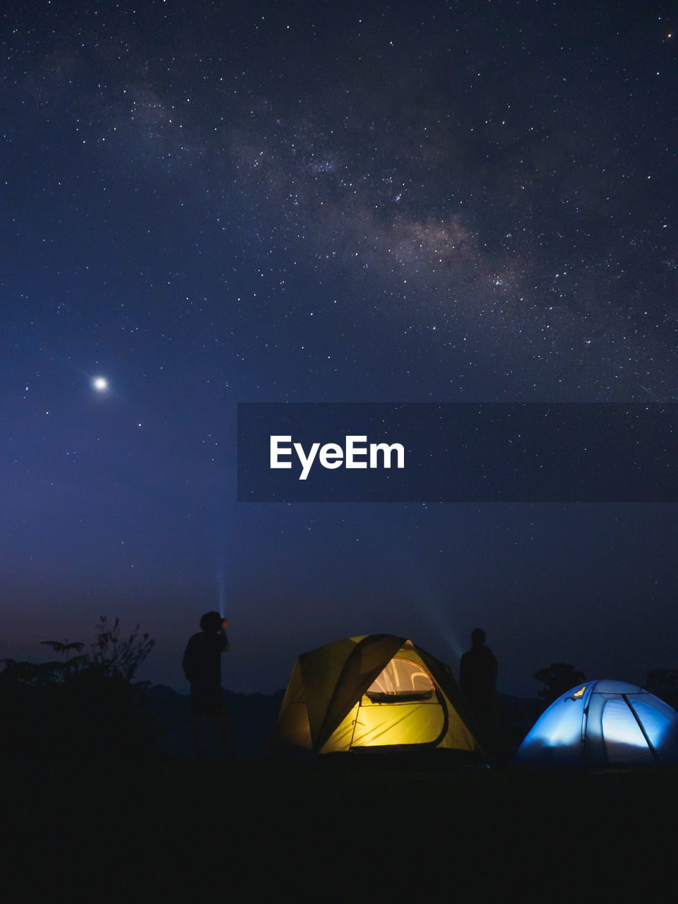 Tourists tents on mountain under the milky way