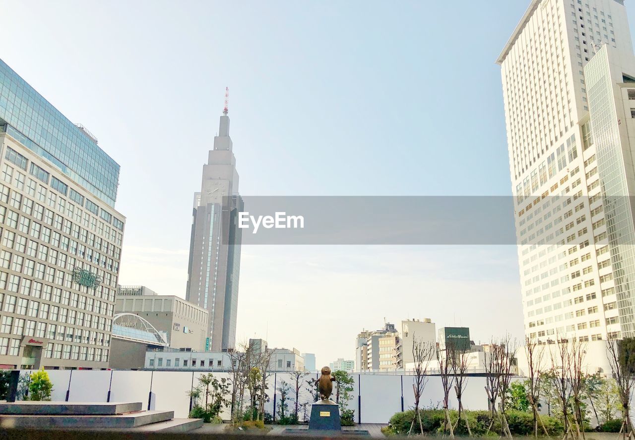 Low angle view of buildings in city against clear sky