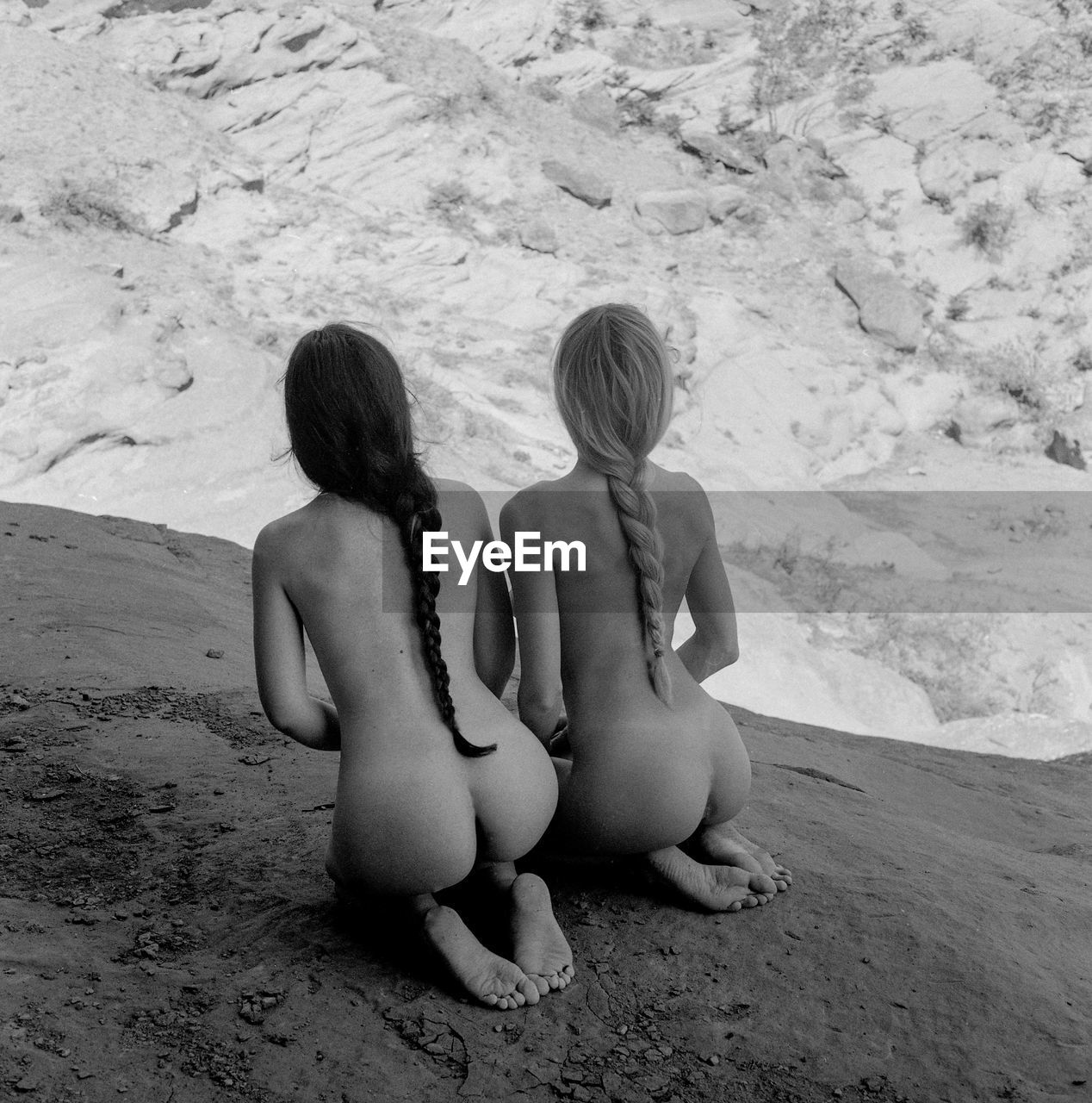 Rear view of women sitting on beach