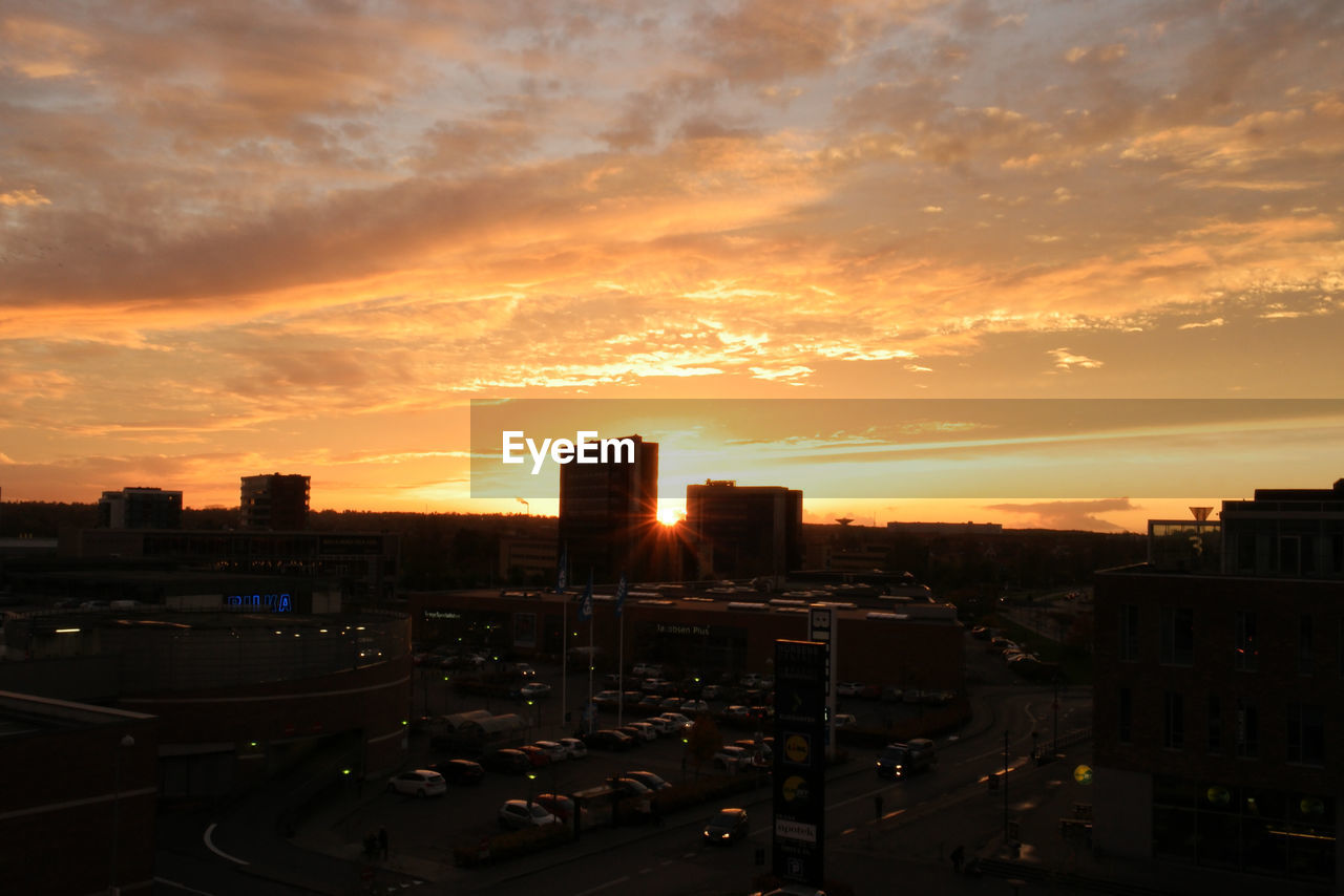 HIGH ANGLE VIEW OF CITYSCAPE AT SUNSET