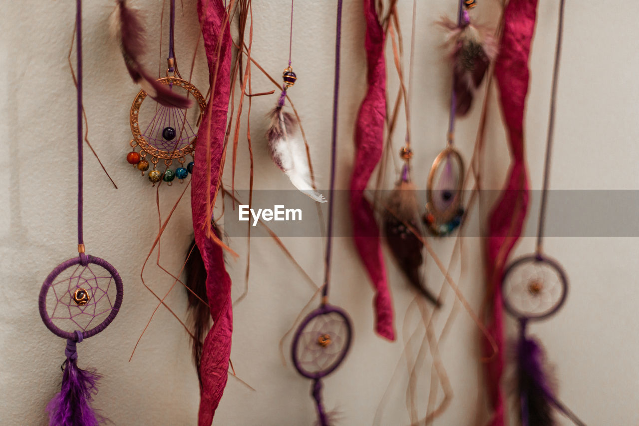 CLOSE-UP OF CLOTHES HANGING ON WALL