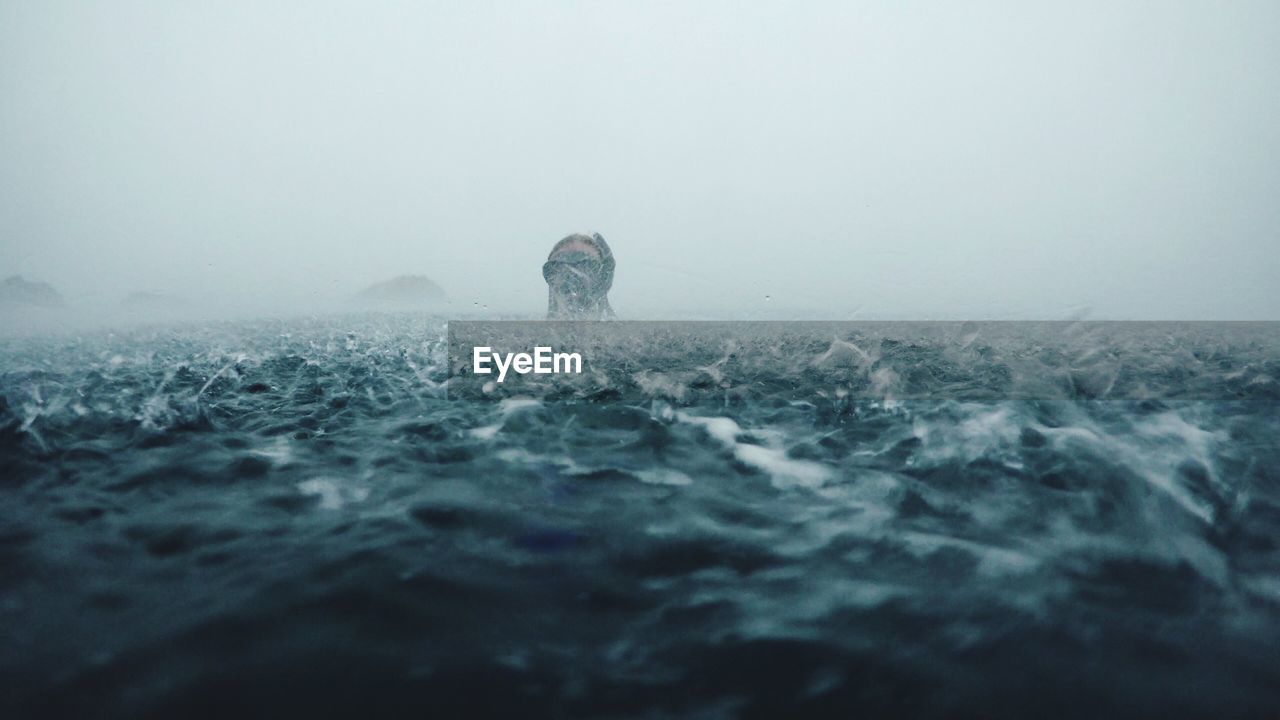 Person swimming in rough sea