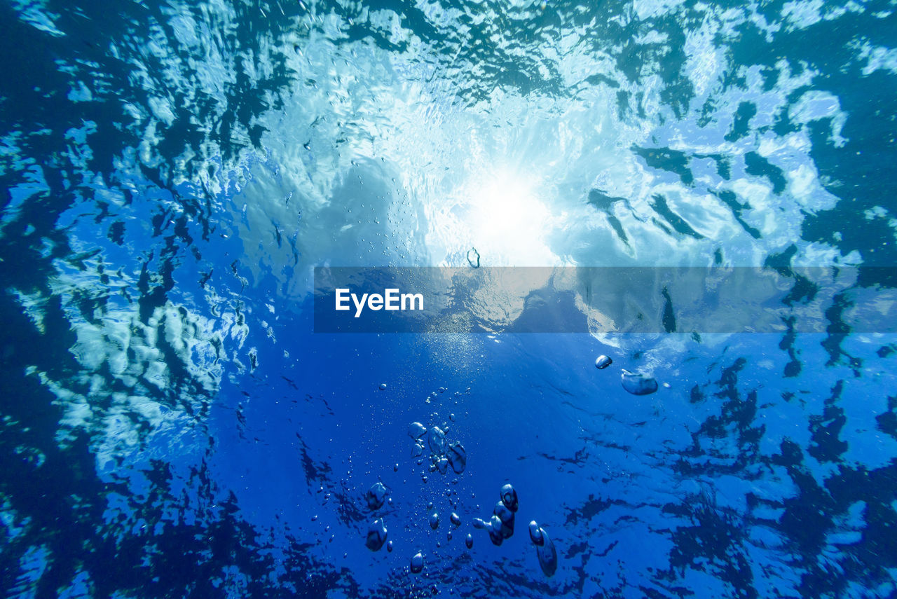 Low angle view of people swimming in sea