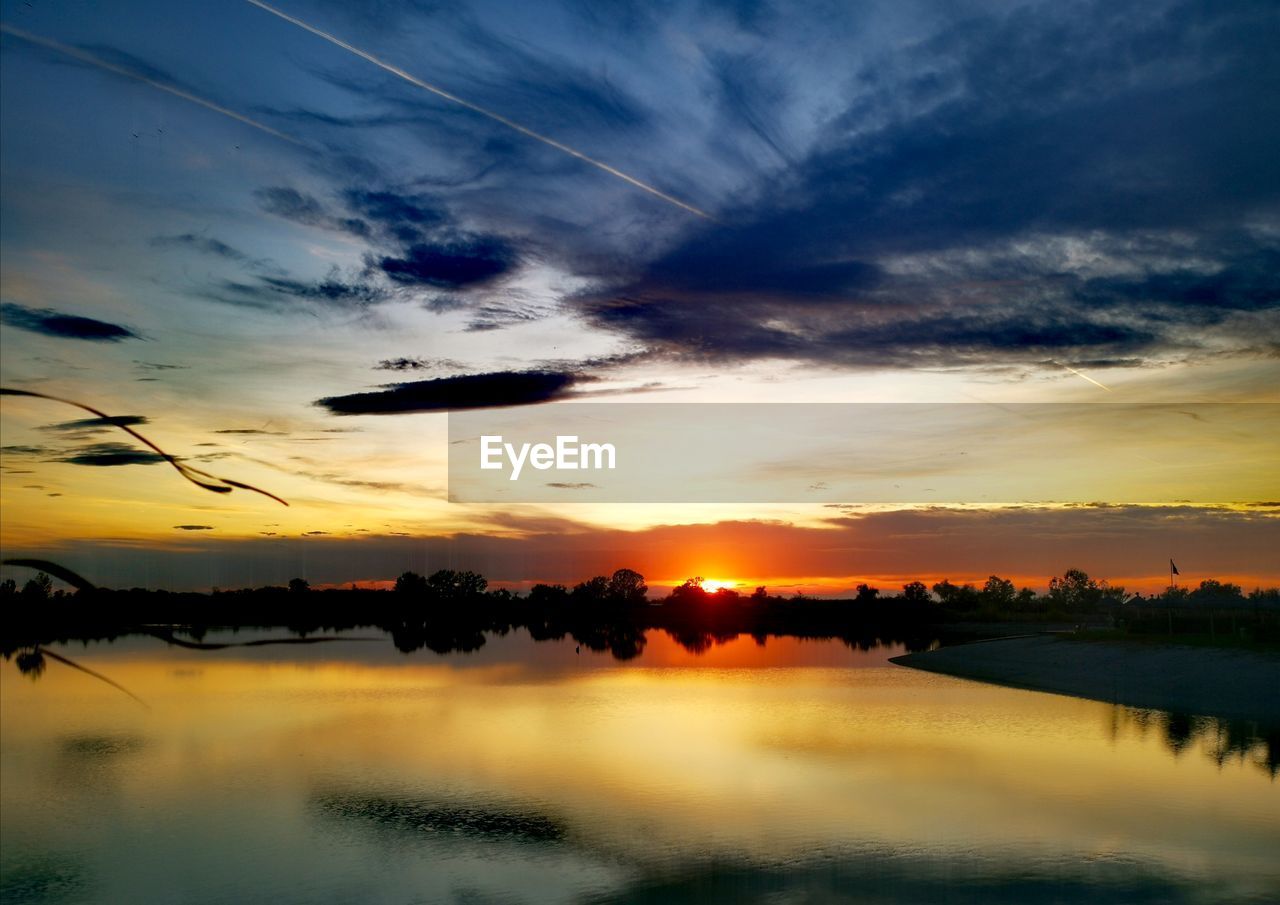 SCENIC VIEW OF LAKE AGAINST ORANGE SKY