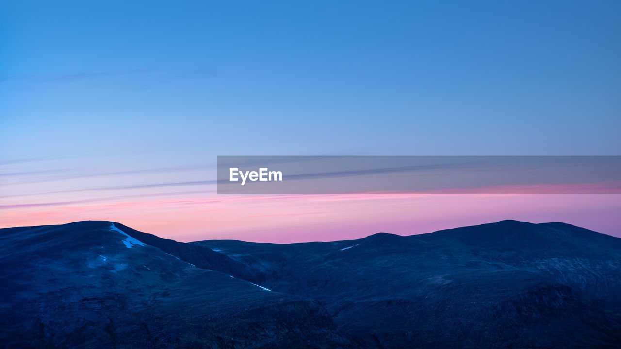 SCENIC VIEW OF MOUNTAIN AGAINST CLOUDY SKY