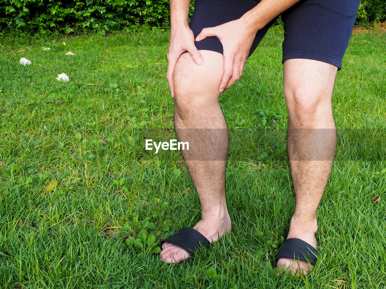 LOW SECTION OF MAN LEGS ON GRASS