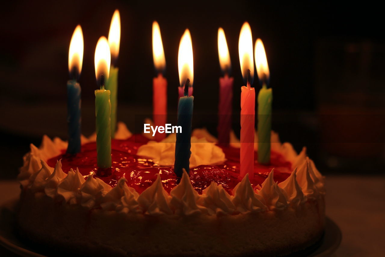 Close-up of burning candles on birthday cake
