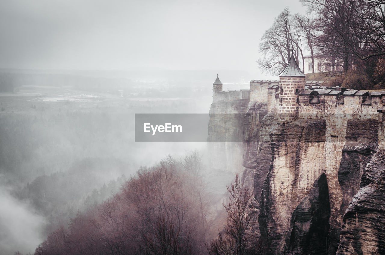 Konigstein fortress on mountain during foggy weather