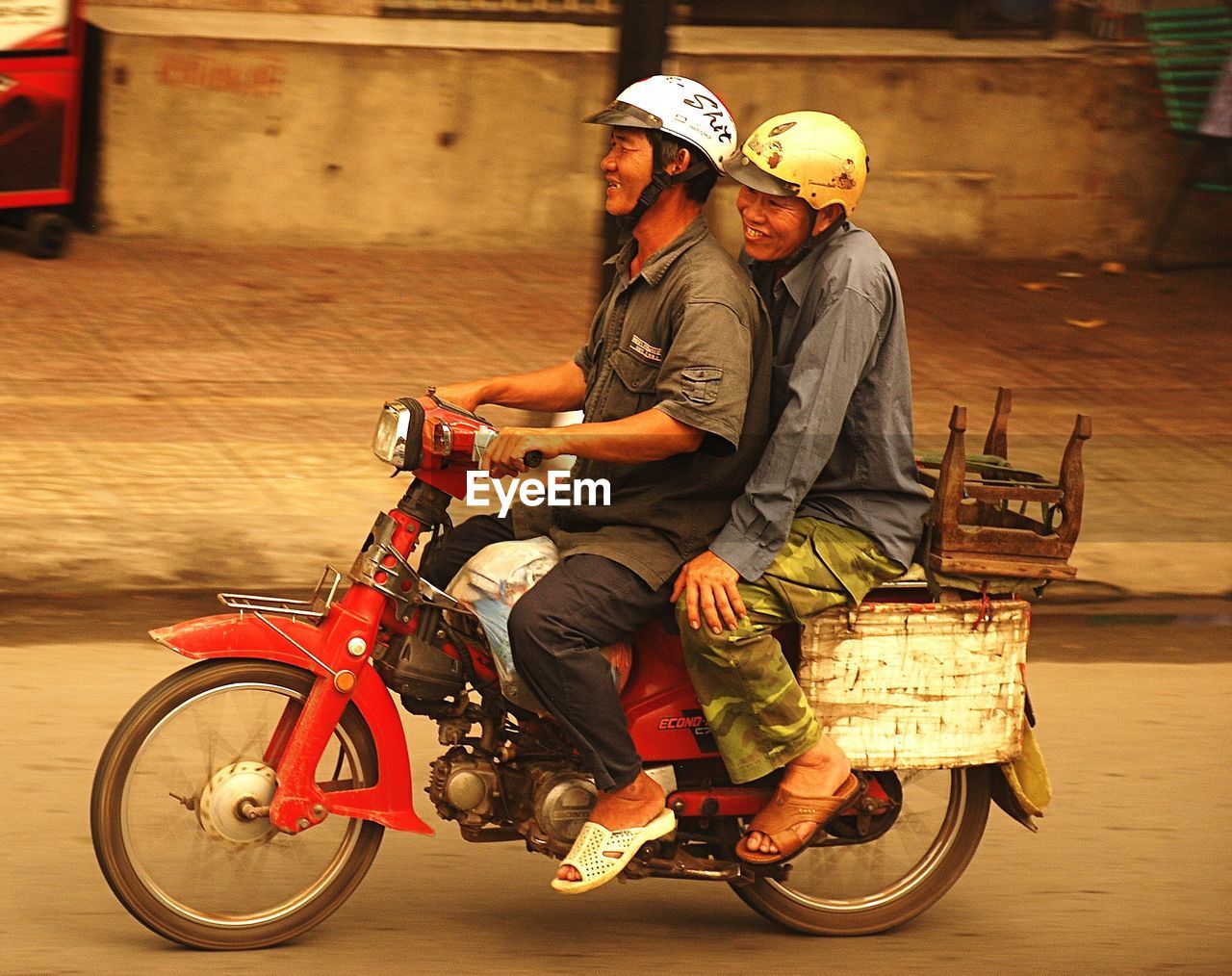 MEN ON MOTORCYCLE AGAINST BLURRED MOTION