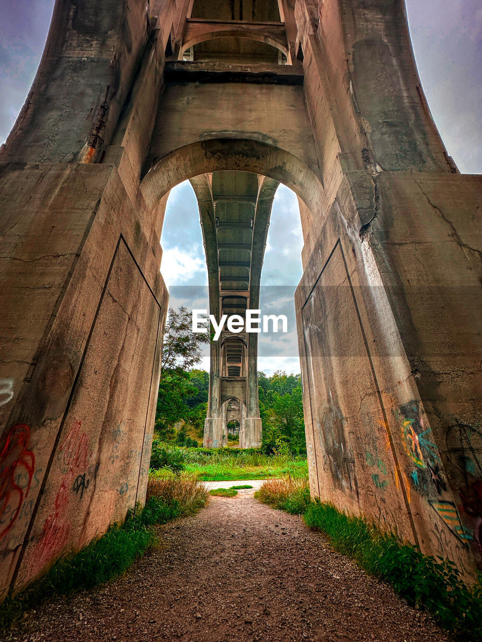 low angle view of bridge against cloudy sky