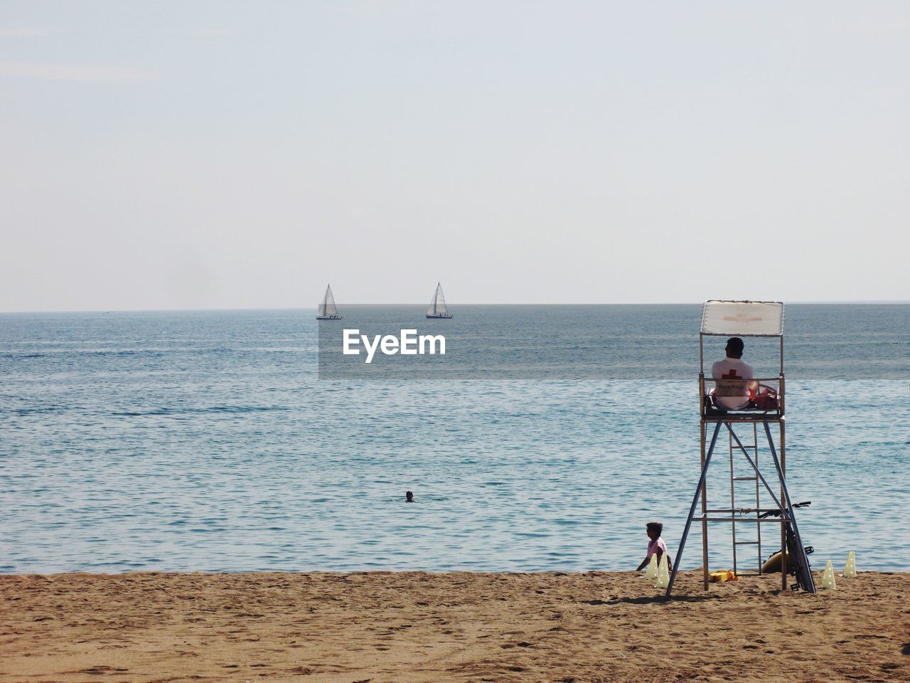 People at beach against sky