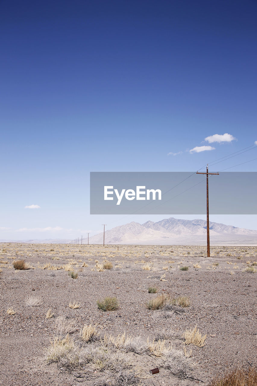 Scenic view of desert against blue sky