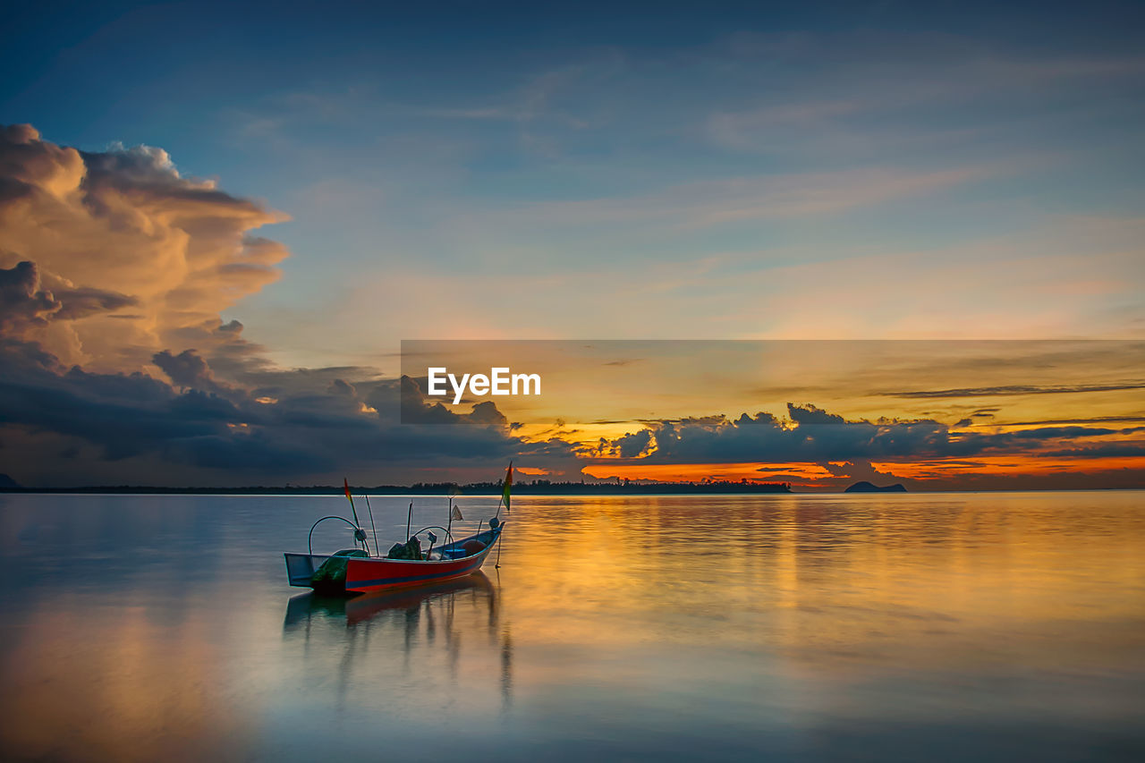 Scenic view of calm sea at sunset