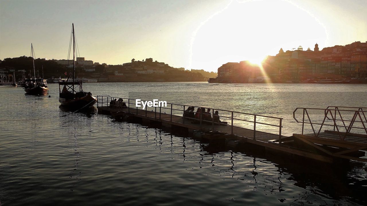 SCENIC VIEW OF RIVER AGAINST SKY AT SUNSET