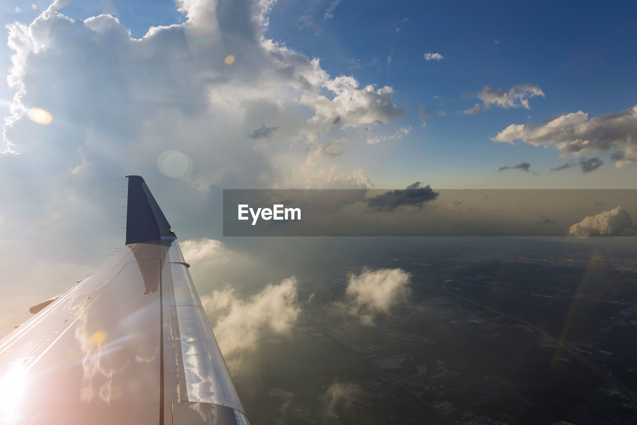 AIRPLANE FLYING OVER CLOUDS