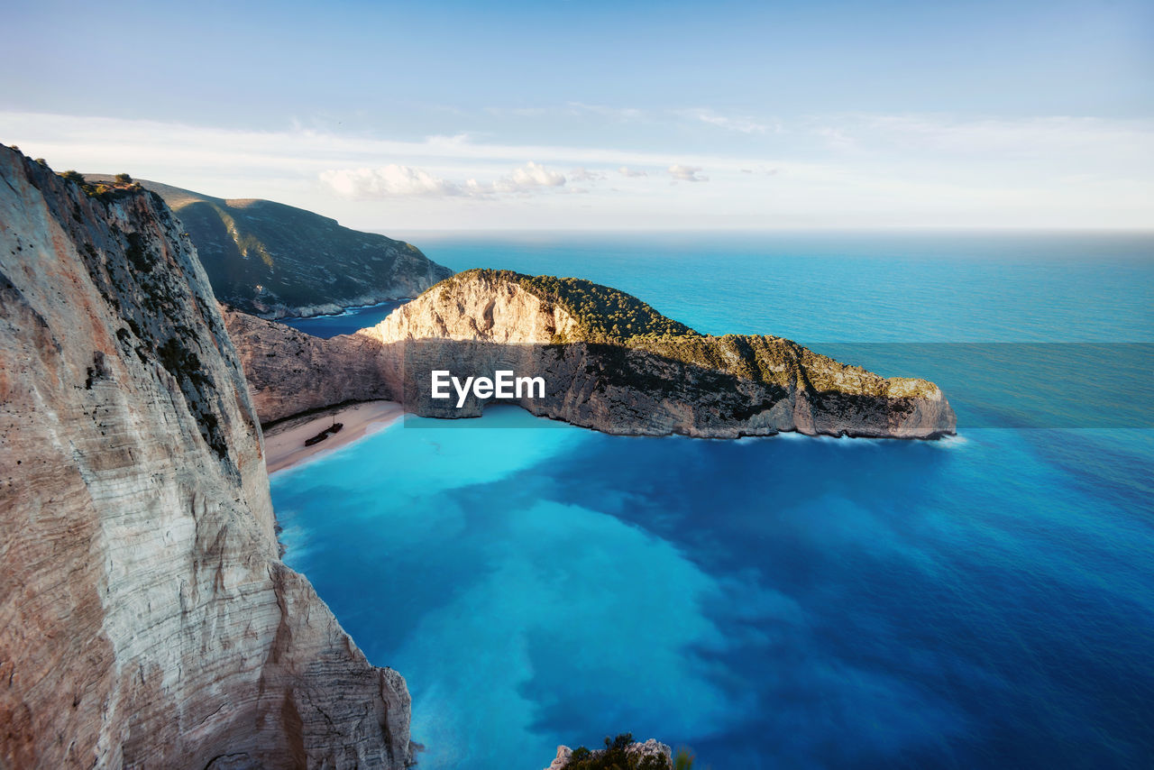 Scenic view of sea and rock formation against sky