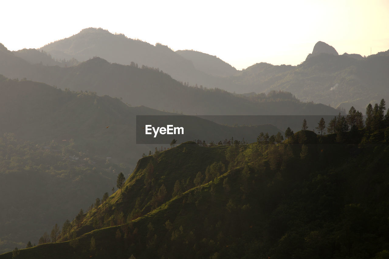 Scenic view of mountains against sky at sunset